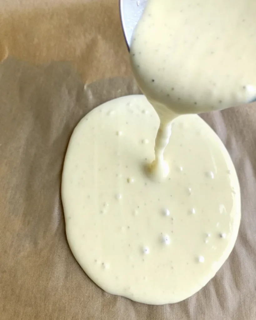 2-Ingredient Cottage Cheese Flatbread – Best Easy Recipe 8 Cottage cheese and egg batter poured onto parchment paper for baking flatbread